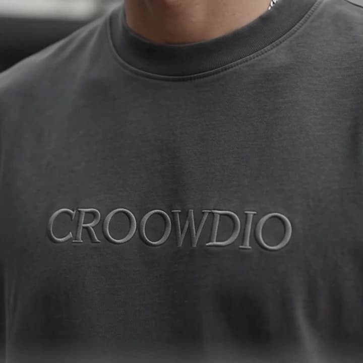 Tonal CROOWDIO embroidery across the chest of a charcoal heavyweight tee.